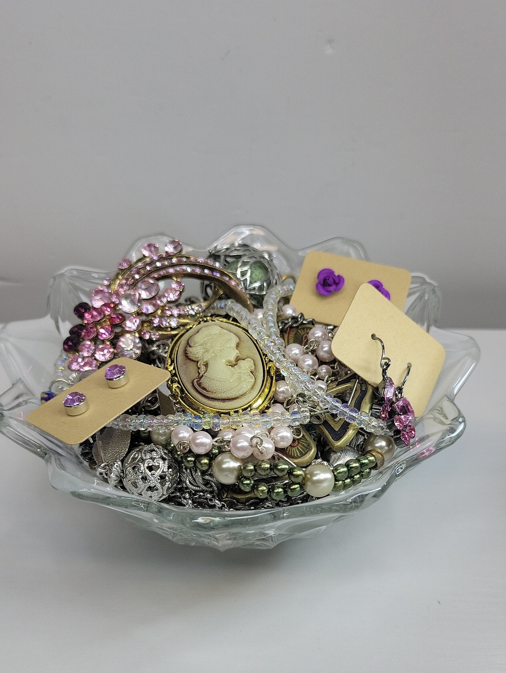 Glass Bowl Filled With Assorted Jewelry